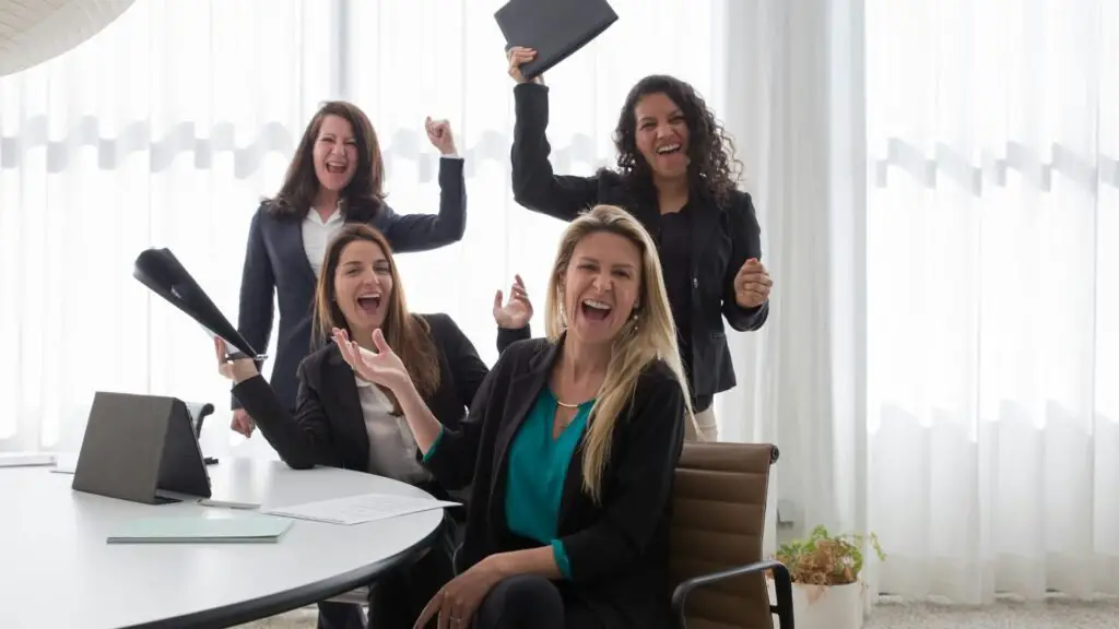 girls in black coat cheering together 