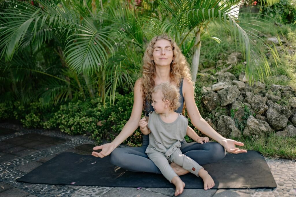 Cheerful women meditating with son