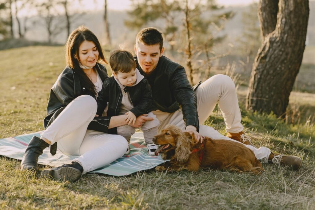 happy family in the park with a small kid and a dog 