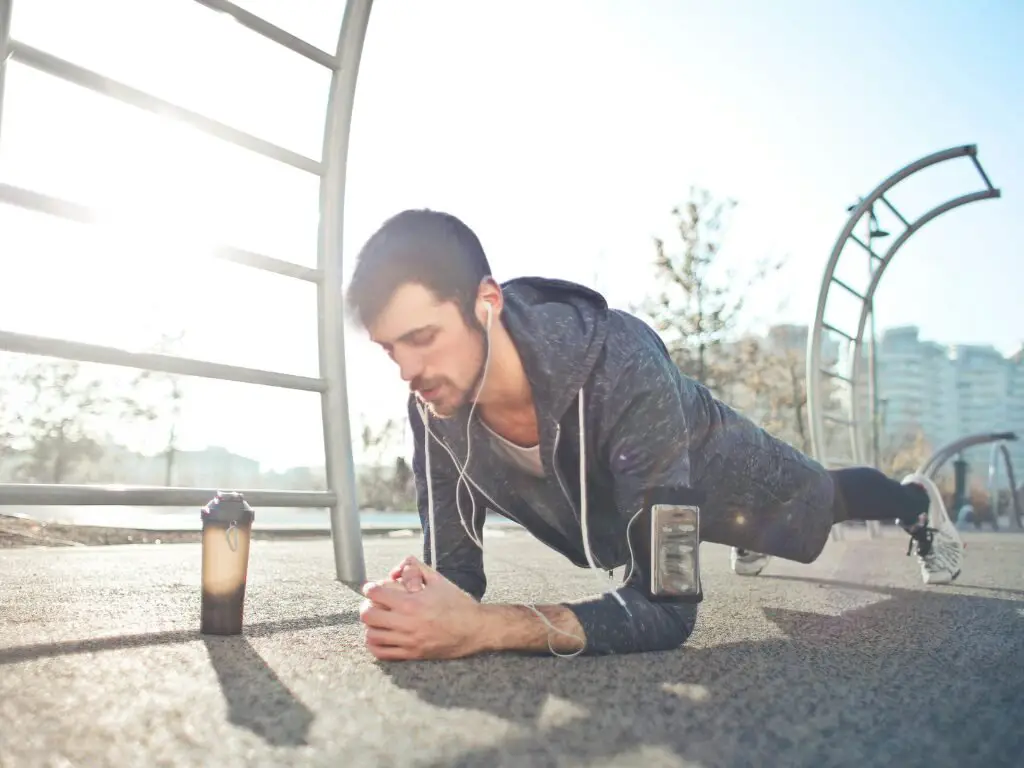 man doing morning plank in the sunlight 