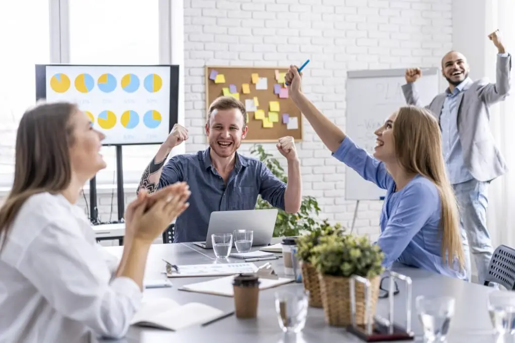 group of people cheering at achieving goals 