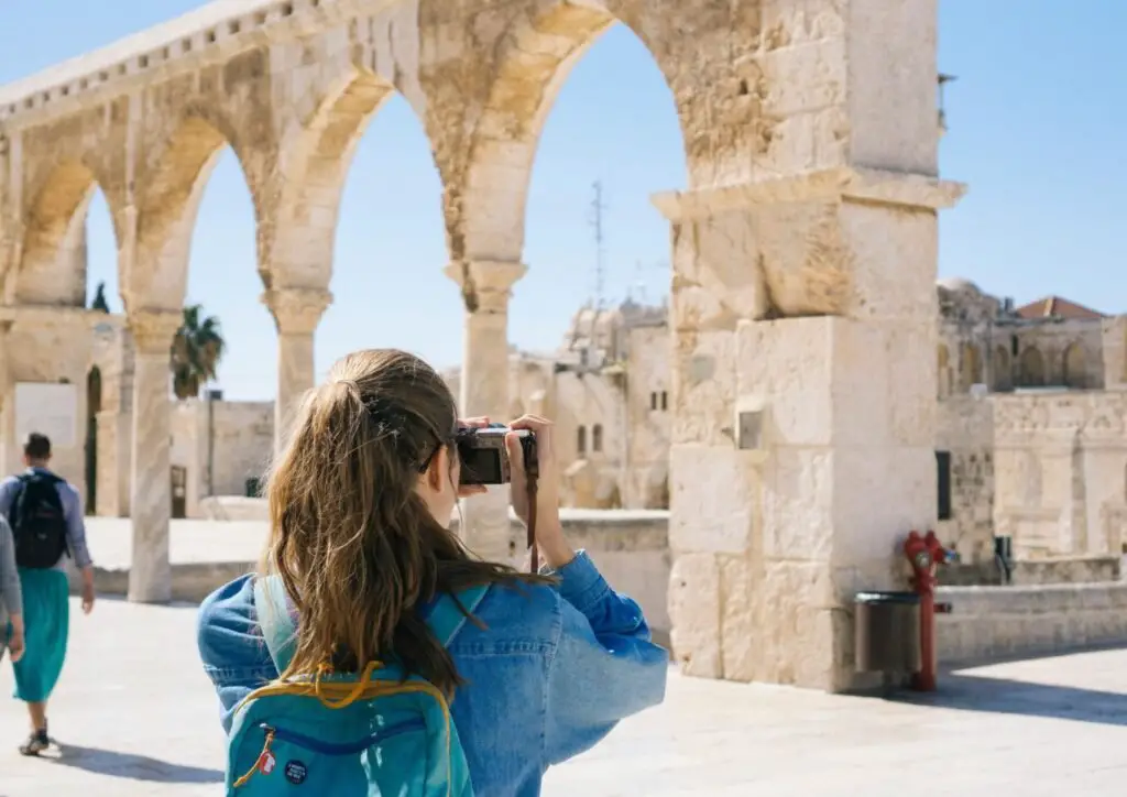 women exploring and taking pictures of monument 