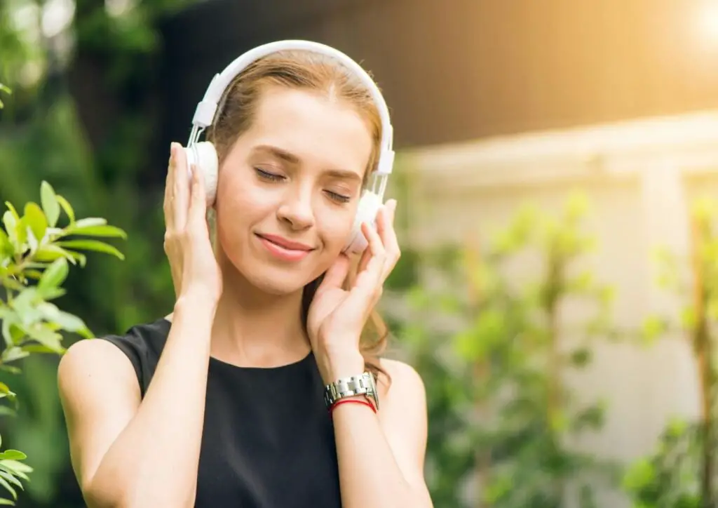 girl enjoying music in the nature 